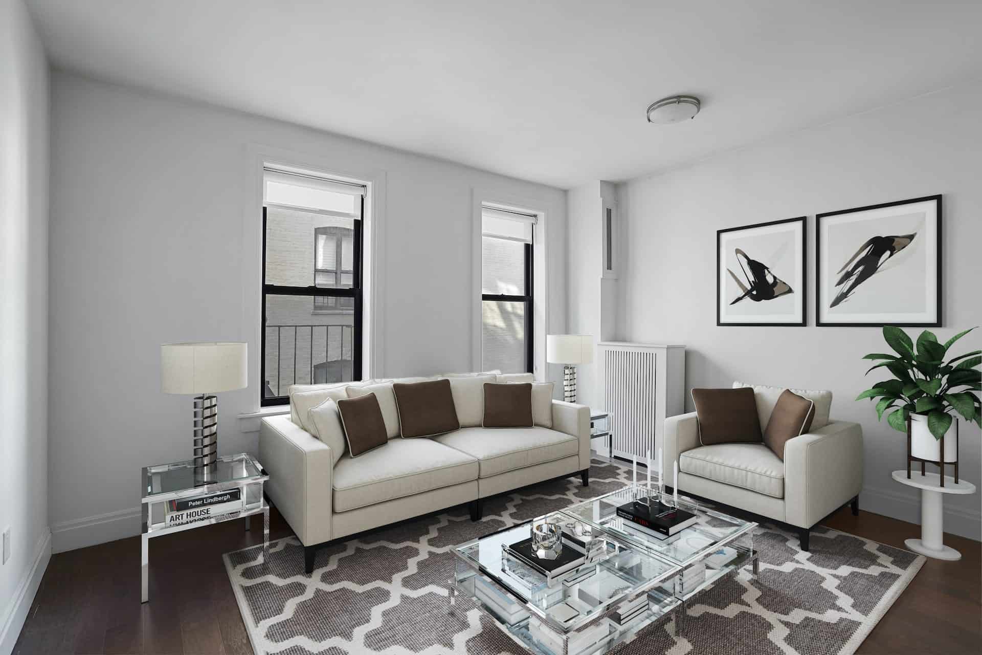 Living room at 556-566 West 126th Street apartments with a couch, chair, glass coffee table, hardwood floors and two windows.