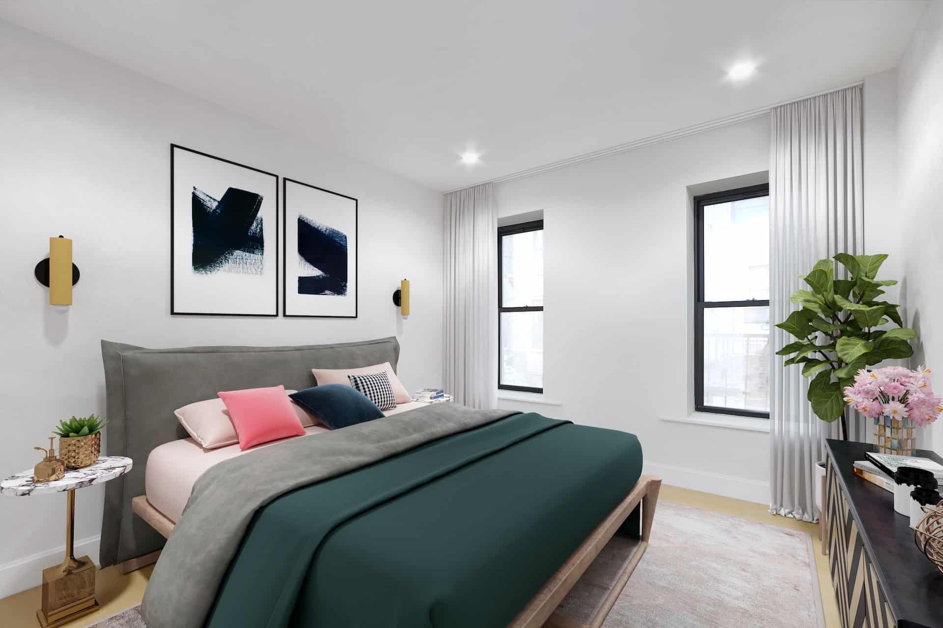 Bedroom at 236 West 10th Street apartments with a king bed, matching side tables, two windows and hardwood floors.