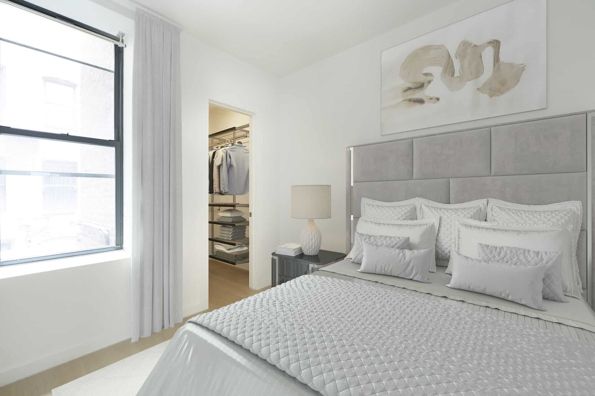 Bedroom at 244 East 7th Street in New York with walk-in closet, queen bed with headboard and large window for natural light.