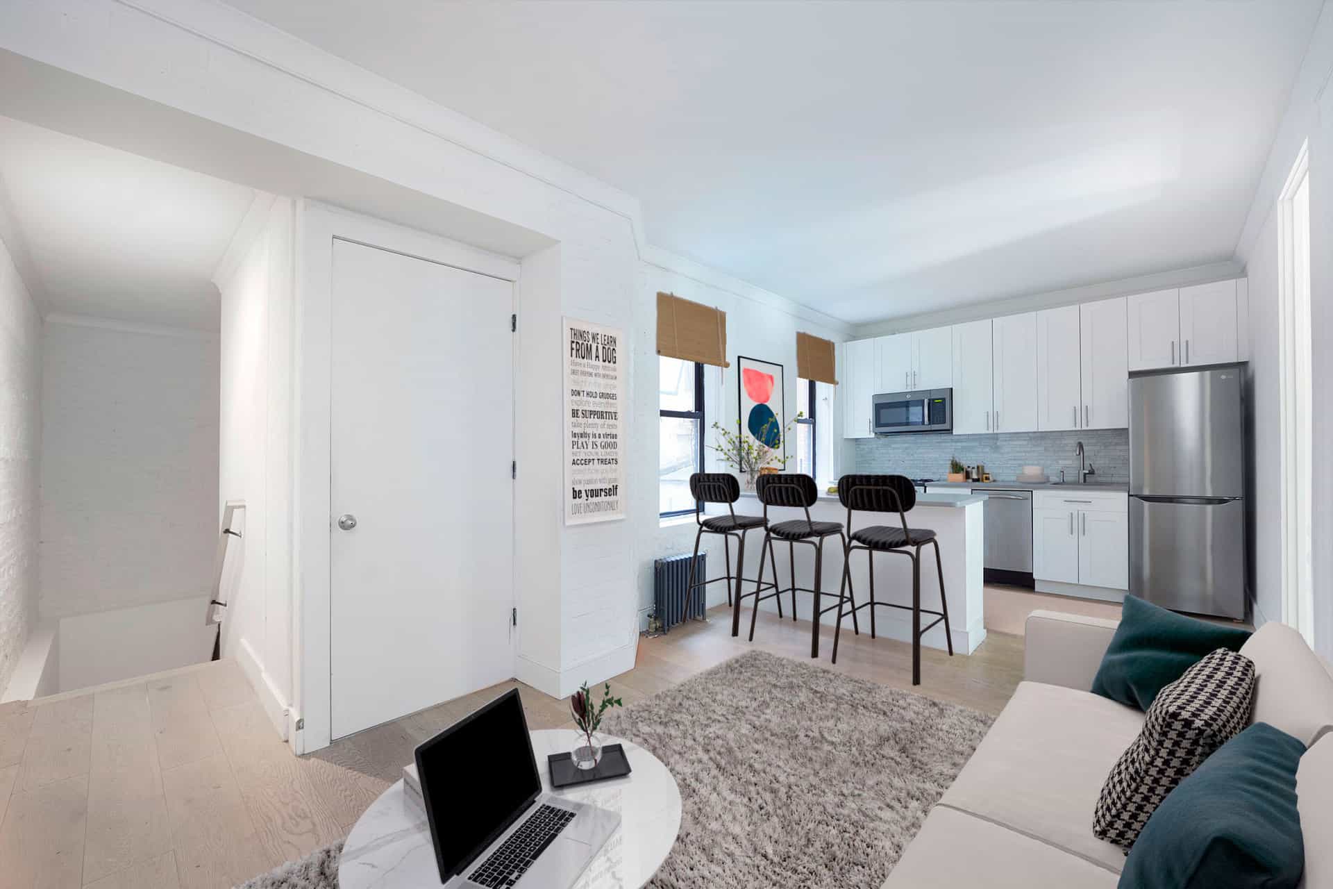 Interior of 245 East 30th Street apartment with hardwood floors, stainless steel appliances and a brown living room rug.