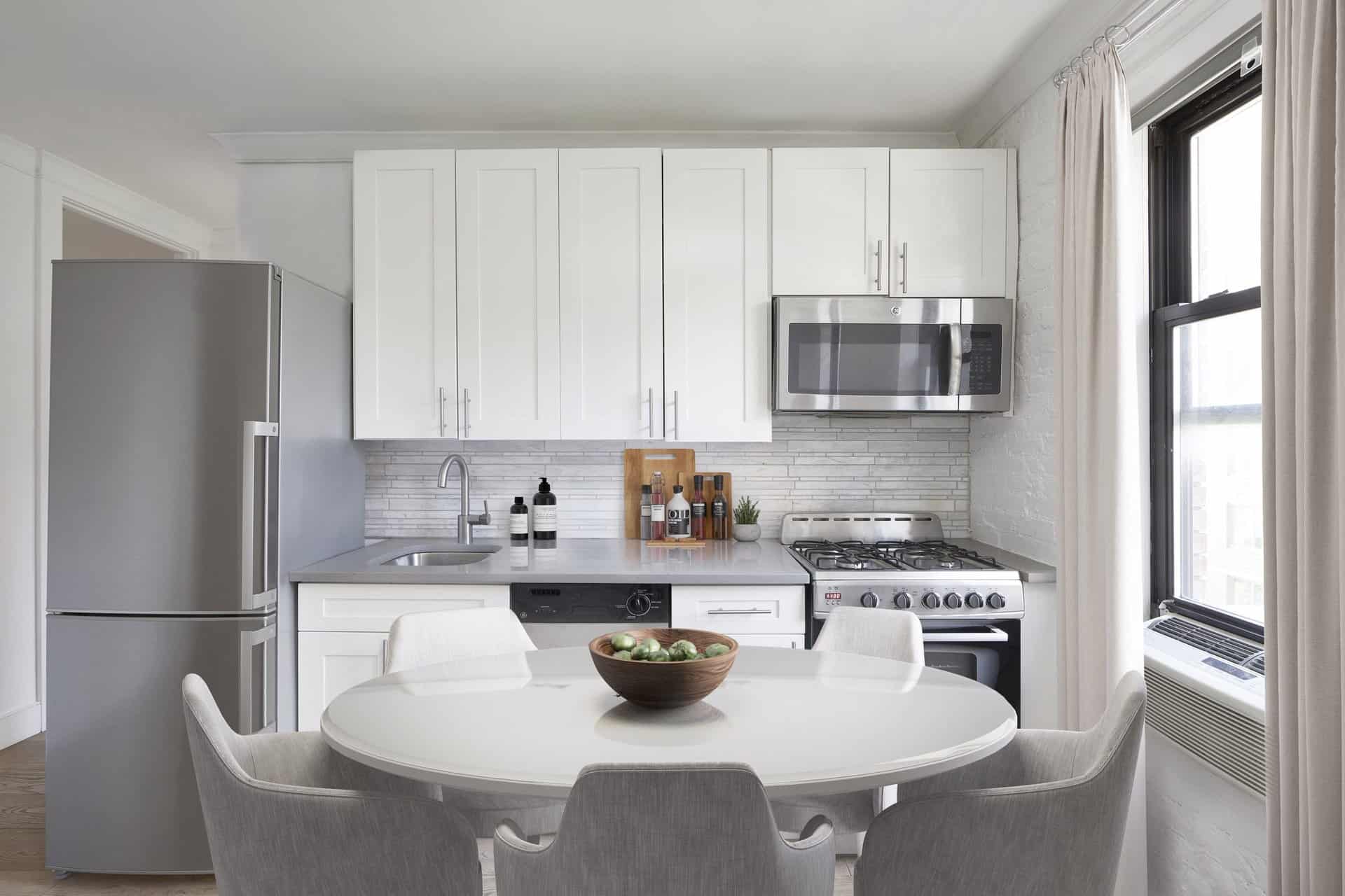Kitchen at 245 East 30th Street apartments in Kips Bay with stone countertops, stainless steel appliances & hardwood floors.
