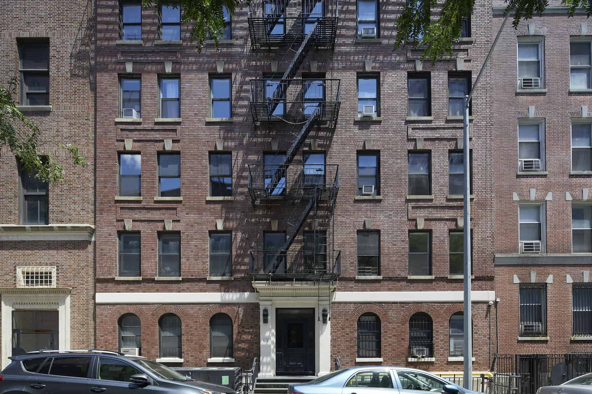Exterior of 245 East 30th Street apartments in Kips Bay. Brick residential building with fire escape down the middle.