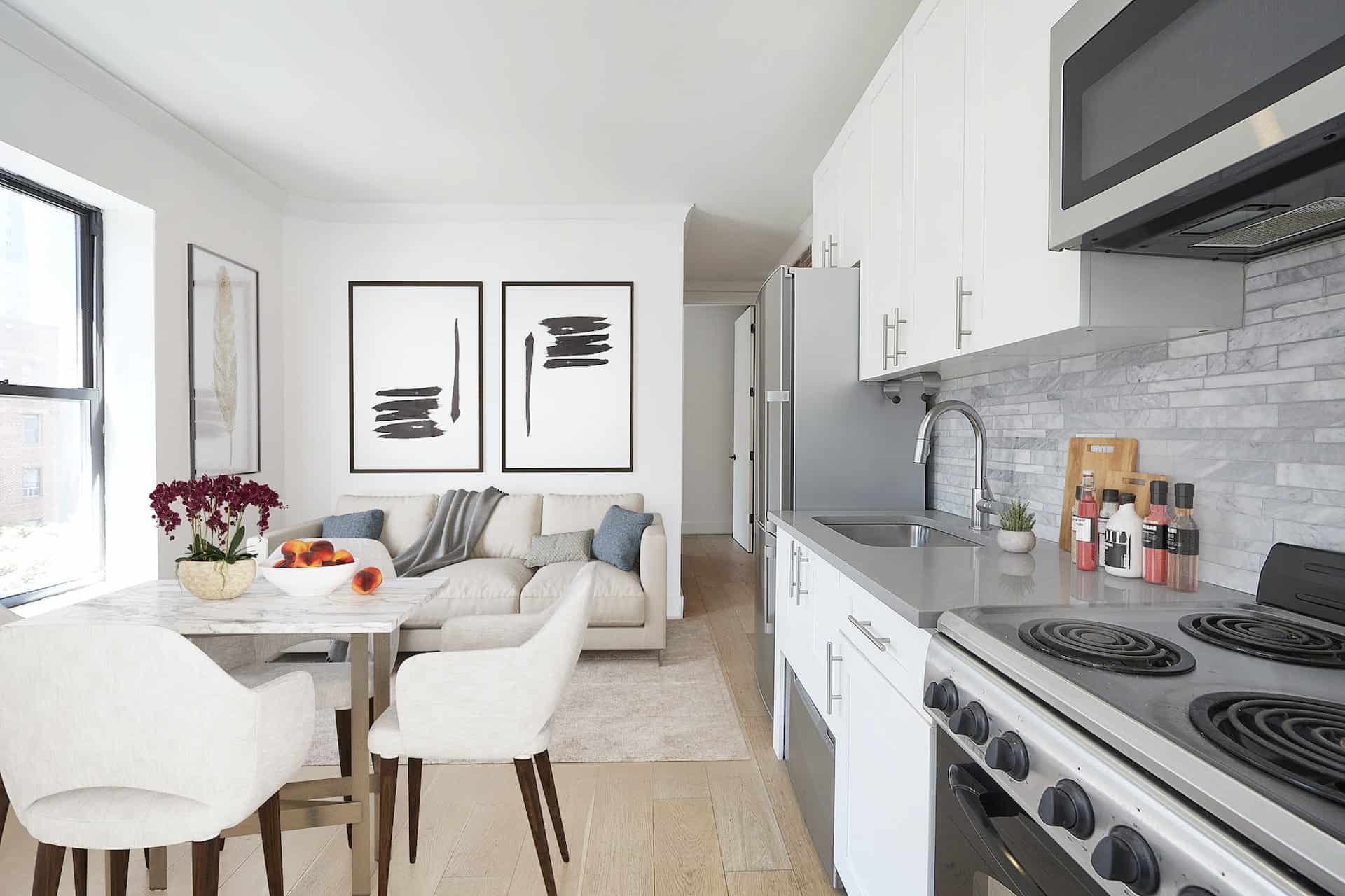 Kitchen at 401 East 50th Street apartments with stone countertops, stainless steel appliances and hardwood floors.