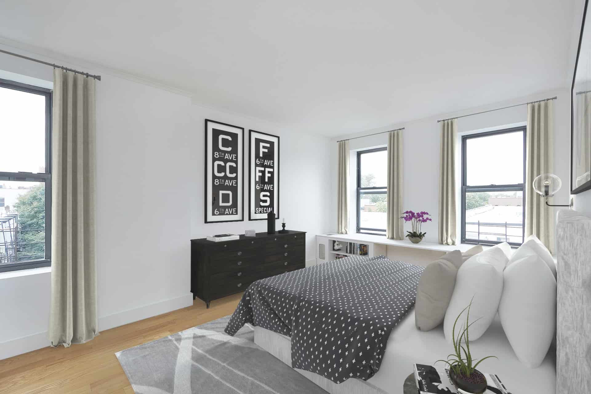 Bedroom at 457 15th Street apartments in Brooklyn with a queen size bed, built-in shelving, natural light & hardwood floors.