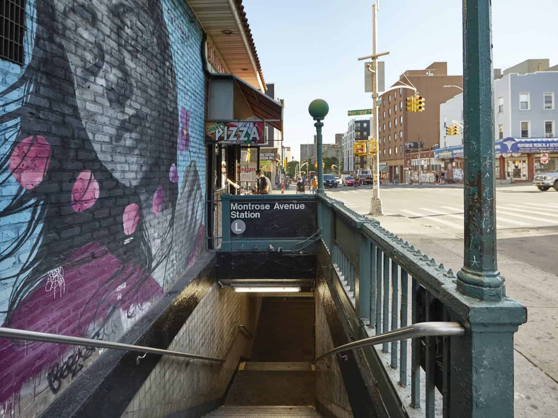 Looking down the stairs to the Montrose Avenue Station in Brooklyn. Steep stairwell with hand rails leading to the subway.