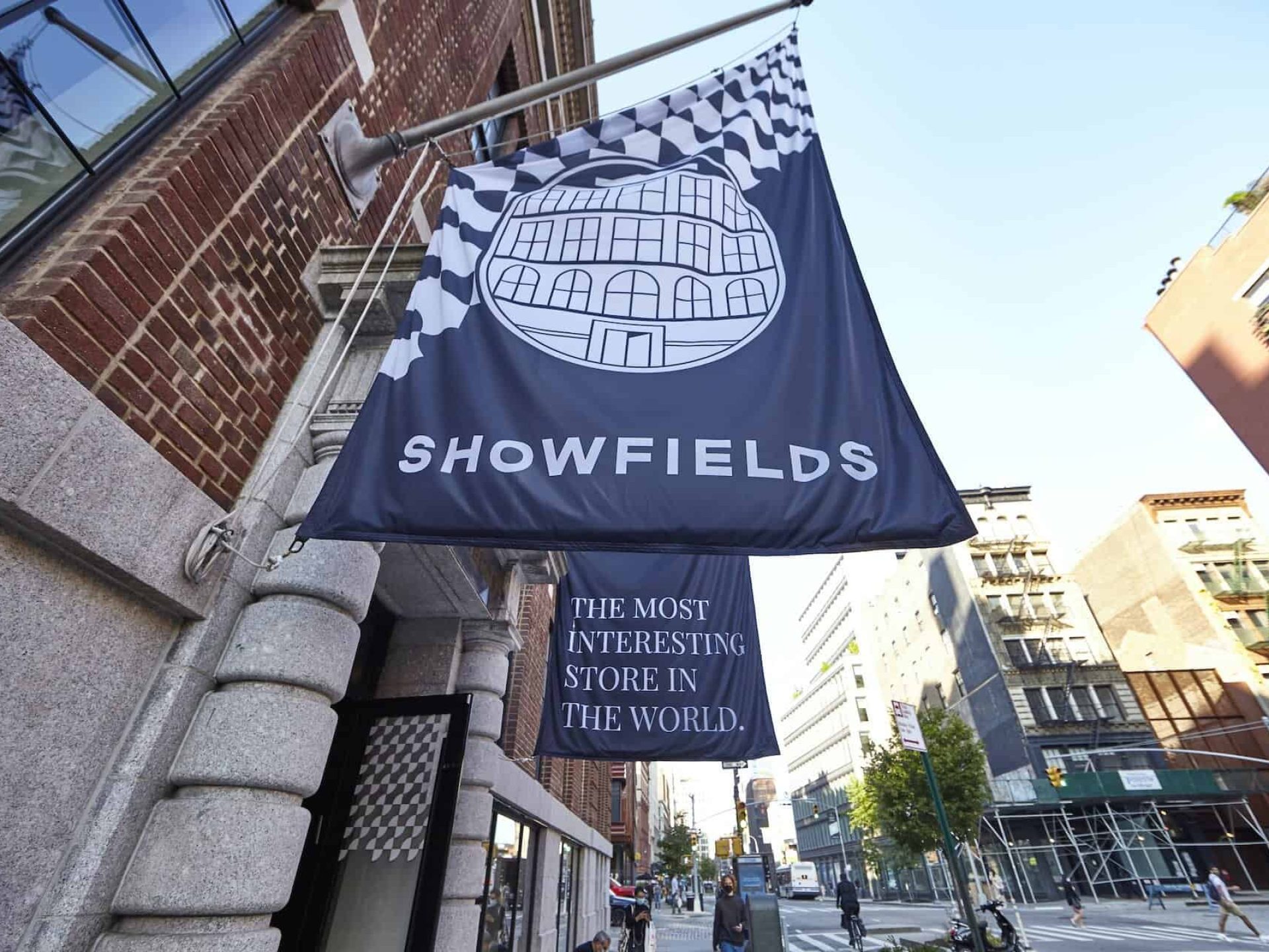 Close up of Showfields banner hanging off of the department store. Large blue banner with white text and designs.