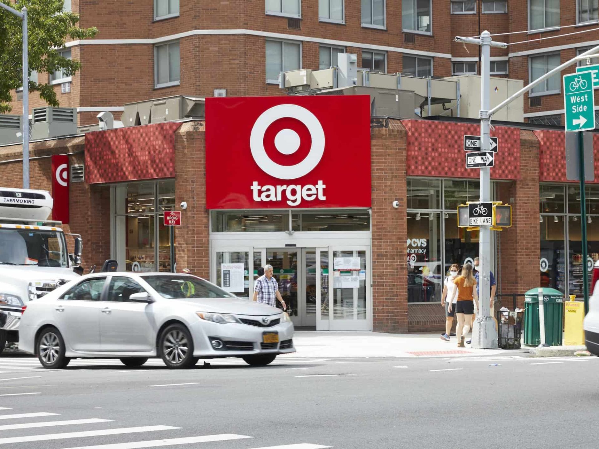 Street view of Target in Murray Hill, New York. Large red Target sign above the double door entrance and people walking.